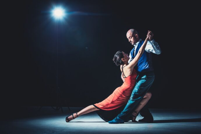 A woman and a man dancing the salsa together