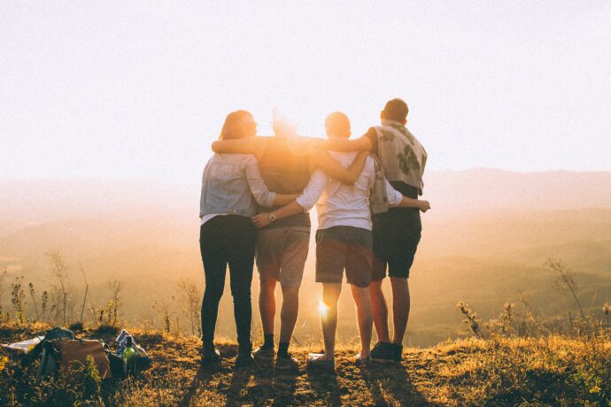 Friends hugging in the sunset